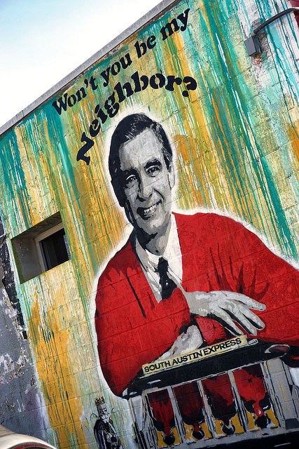 Mr Rogers Mural of Mr Rogers wearing red cardigan on side of building