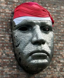 Soldiers trauma and brain injury  Photo of large mask on brick wall